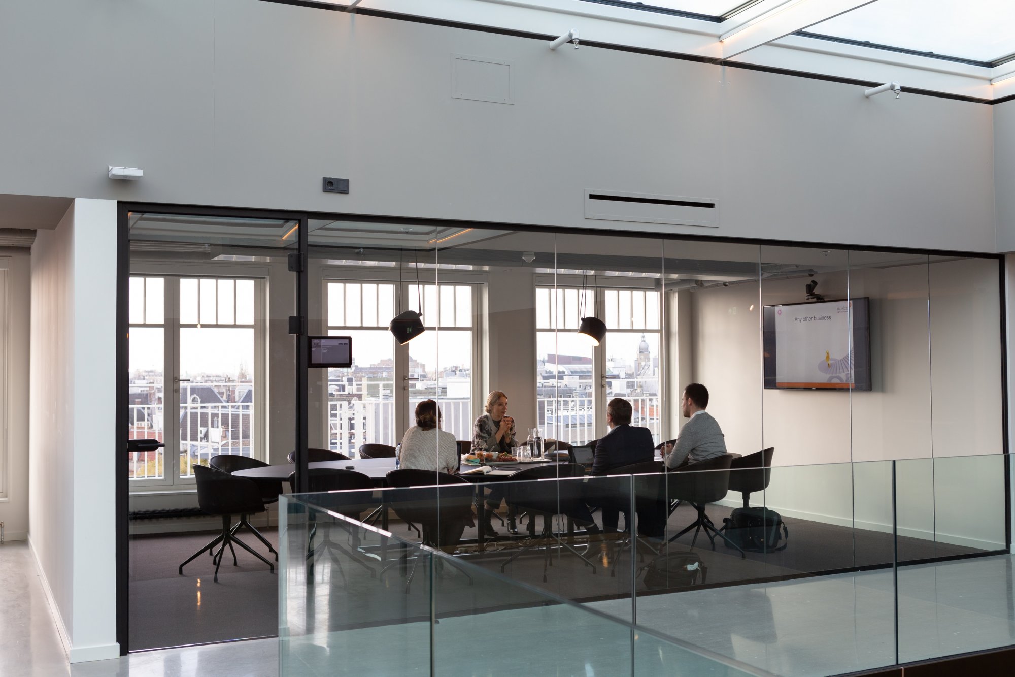 Company executives sitting around a board room table.