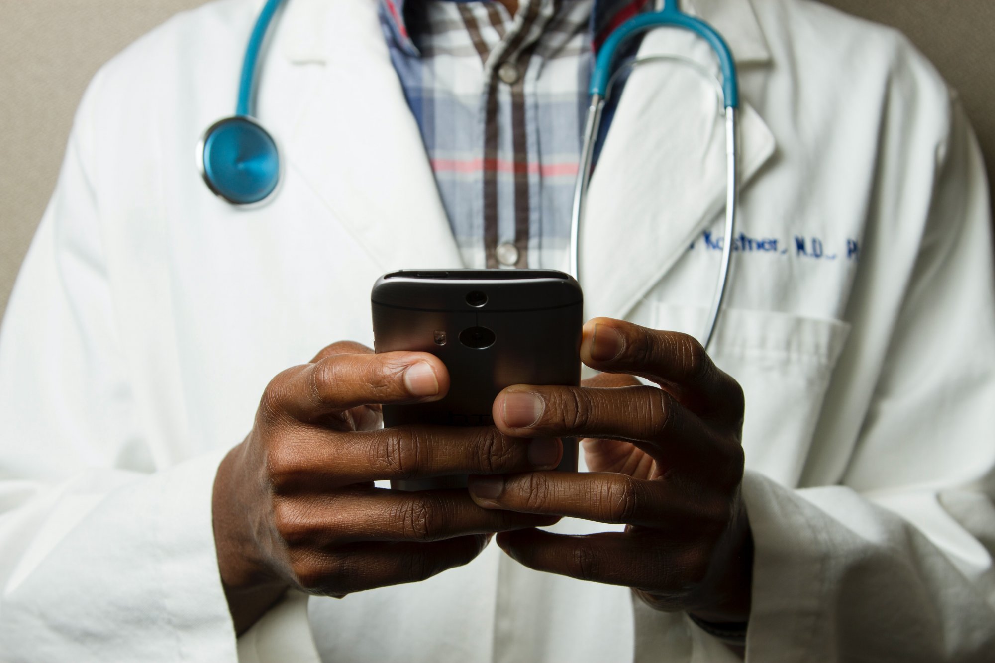 A male doctor with a smartphone.